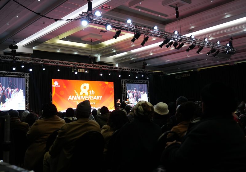 Large LED screen event setup with side screens, truss, lighting and audience.