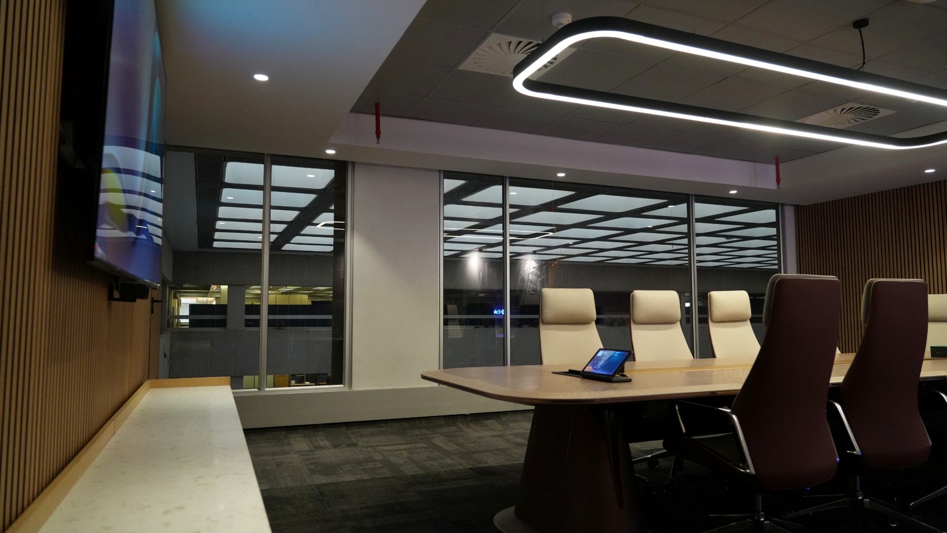 Premium boardroom with meeting table and integrated collaboration technology.