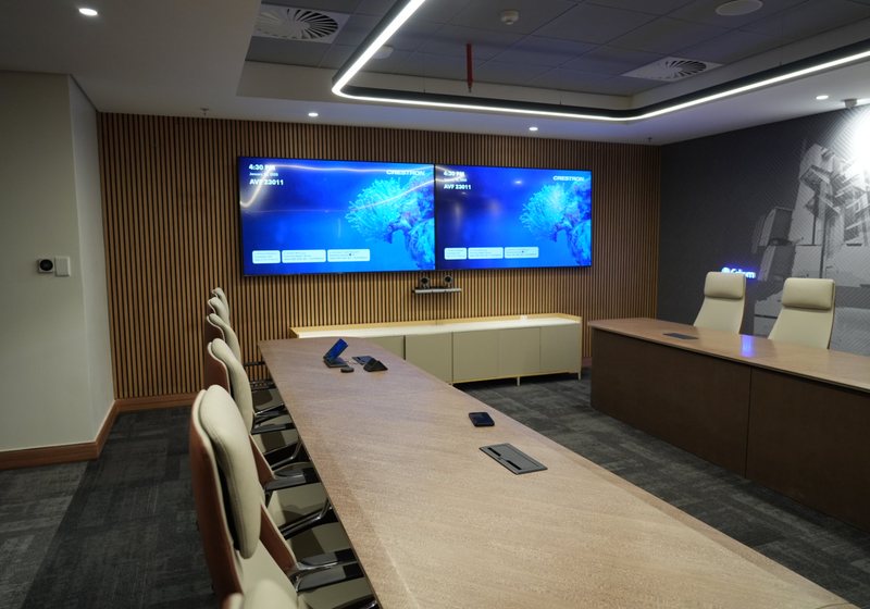 Dual wall displays with a conferencing camera above a credenza in a boardroom