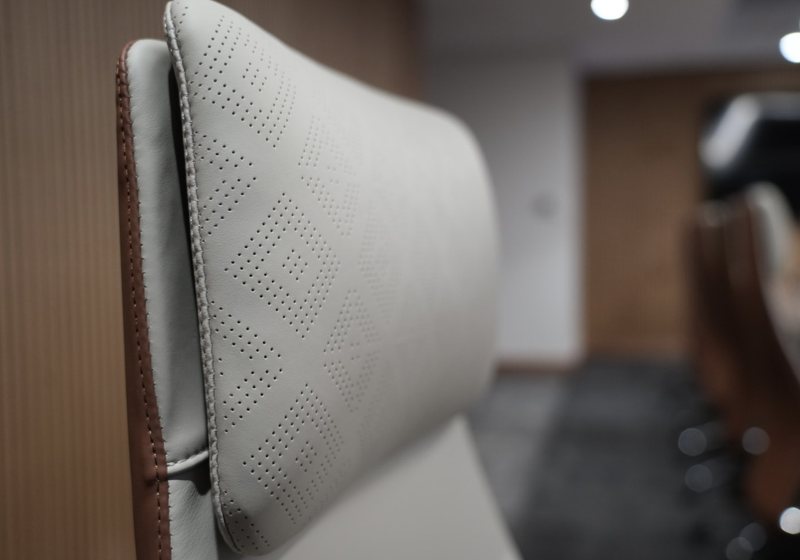 Close-up of a perforated leather executive chair headrest