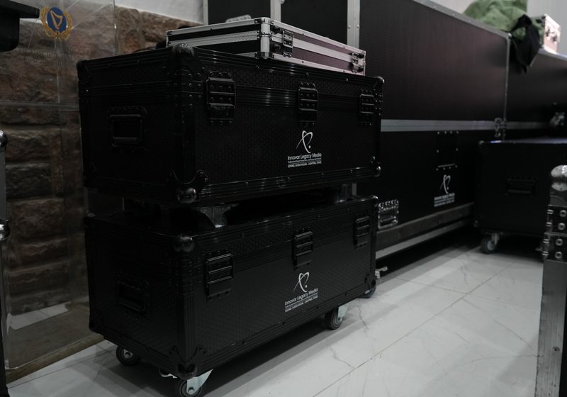 Two stacked black Innovar Legacy Media flight cases on castors beside a larger case